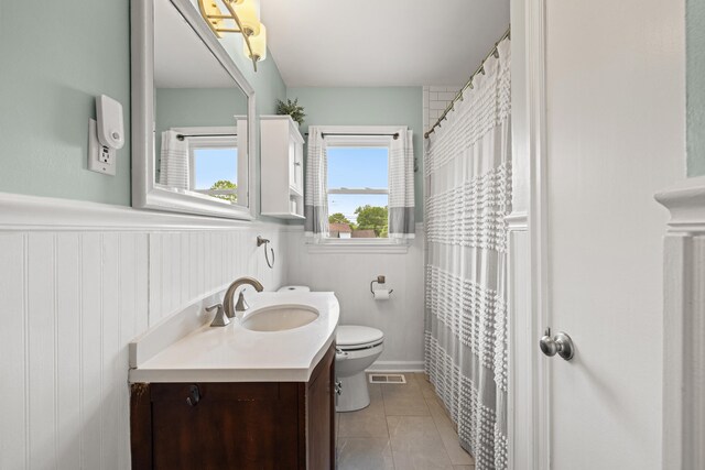298 Hill N Dale Rd, Lexington, KY 40503 - bathroom with toilet, vanity, a wainscoted wall, and tile patterned flooring
