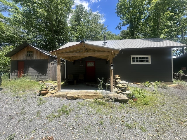 853 Rock Springs Rd, Celina, TN 38551 - view of front facade with metal roof and a carport