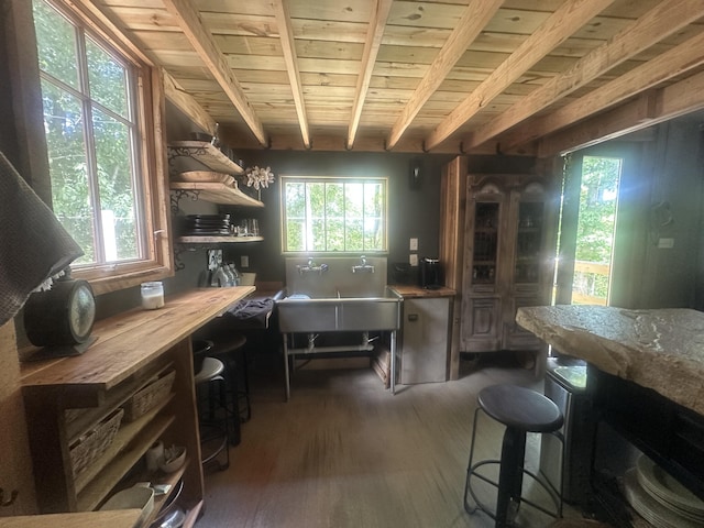 853 Rock Springs Rd, Celina, TN 38551 - kitchen featuring wooden ceiling with exposed beams, dark wood-style floors, open shelves, and a kitchen bar