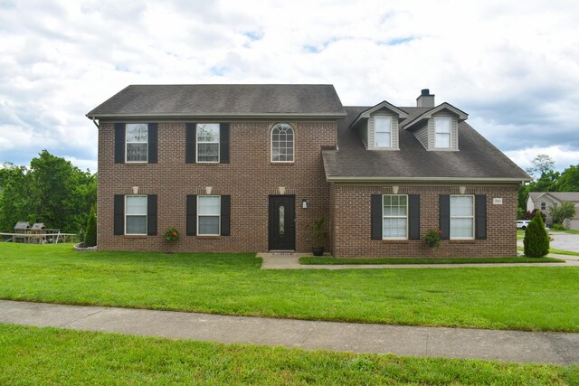 200 Manoah Ln, Nicholasville, KY 40356 - colonial house featuring a chimney, a front lawn, brick siding, and a shingled roof