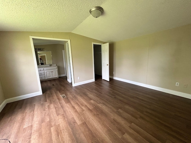 376 Cumberland Dr, Burnside, KY 42519 - unfurnished bedroom with dark wood-style flooring, lofted ceiling, baseboards, a closet, and a textured ceiling
