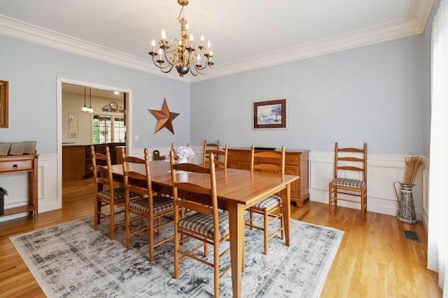 512 Water Cliff Dr, Somerset, KY 42503 - dining area with a chandelier, light wood-style flooring, ornamental molding, and a wainscoted wall