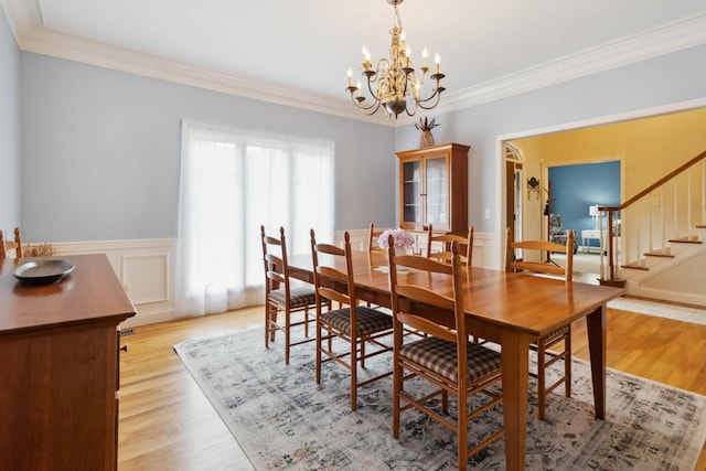 512 Water Cliff Dr, Somerset, KY 42503 - dining room with a chandelier, stairs, crown molding, light wood-type flooring, and a wainscoted wall