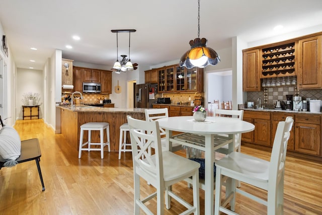 512 Water Cliff Dr, Somerset, KY 42503 - dining room with light wood-style floors, wet bar, a chandelier, and recessed lighting