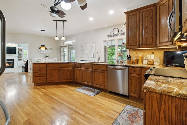 512 Water Cliff Dr, Somerset, KY 42503 - kitchen featuring stainless steel appliances, a sink, ceiling fan, brown cabinets, and healthy amount of natural light