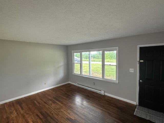 10650 Georgetown Rd, Owenton, KY 40359 - empty room with a baseboard heating unit, a textured ceiling, and dark wood-type flooring