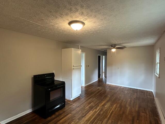 10650 Georgetown Rd, Owenton, KY 40359 - unfurnished living room featuring dark wood-style flooring, ceiling fan, and a textured ceiling