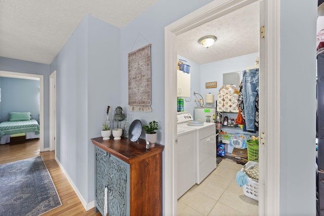 117 Autumn Dr, Russell Springs, KY 42642 - laundry room with washer and clothes dryer, a textured ceiling, light wood finished floors, and baseboards