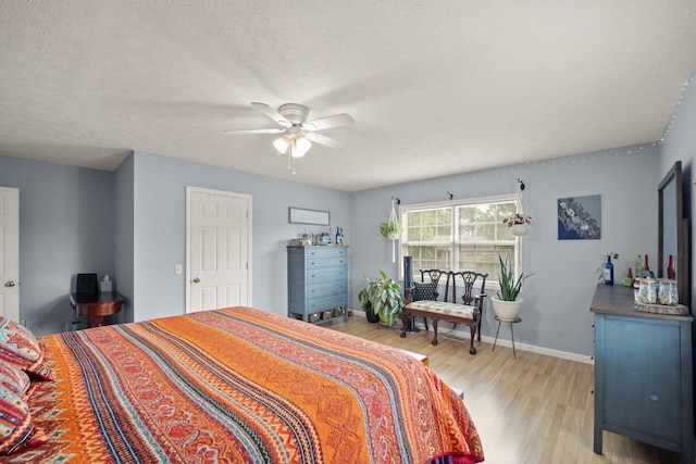 117 Autumn Dr, Russell Springs, KY 42642 - bedroom featuring light wood-style flooring, a textured ceiling, baseboards, and ceiling fan