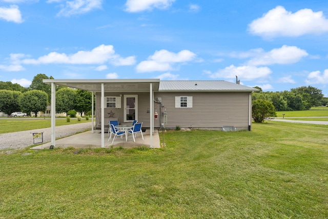 117 Autumn Dr, Russell Springs, KY 42642 - back of property with a patio, a lawn, and metal roof