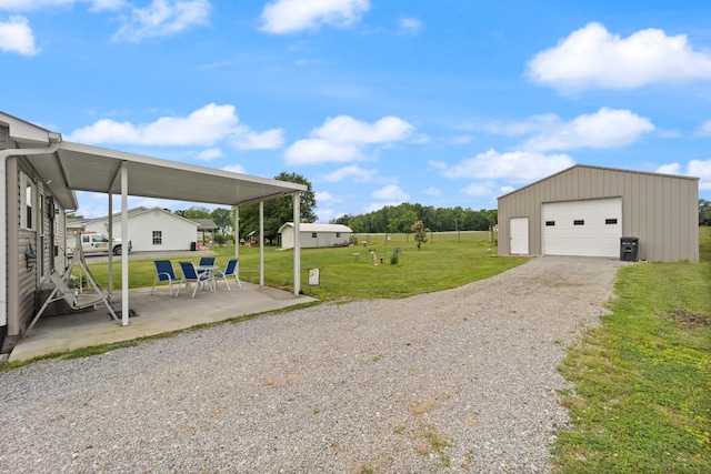 117 Autumn Dr, Russell Springs, KY 42642 - view of grassy yard with an outbuilding, a garage, gravel driveway, and a patio