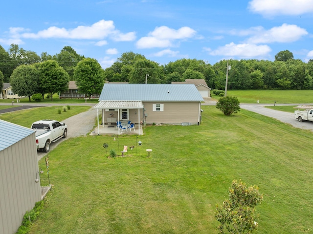 117 Autumn Dr, Russell Springs, KY 42642 - rear view of property featuring a lawn, metal roof, and a patio