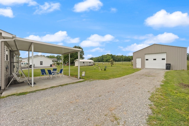 117 Autumn Dr, Russell Springs, KY 42642 - view of green lawn with an outdoor structure, a garage, a patio, and gravel driveway
