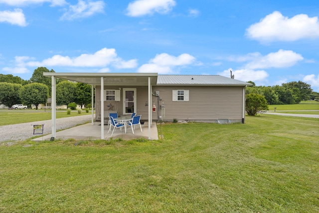 117 Autumn Dr, Russell Springs, KY 42642 - rear view of house with a patio area, a lawn, and metal roof