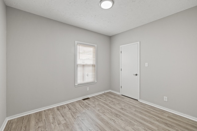 110 Hazel Ave, Lexington, KY 40502 - empty room with light wood-type flooring, baseboards, and a textured ceiling