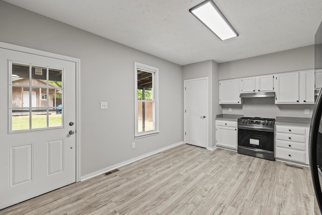 110 Hazel Ave, Lexington, KY 40502 - kitchen featuring gas range, under cabinet range hood, light wood finished floors, and white cabinets