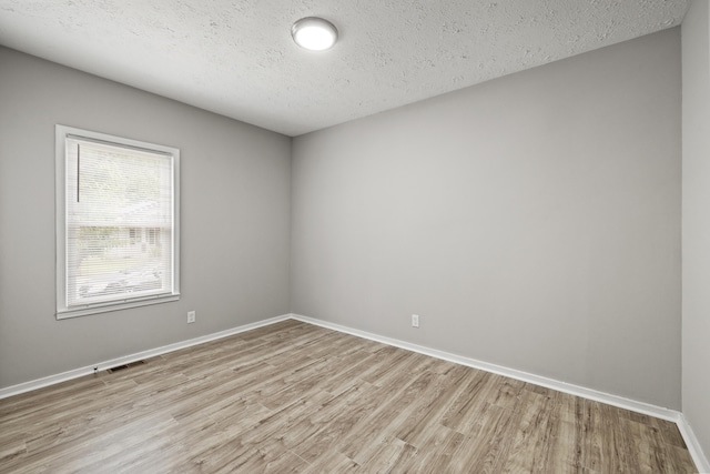 110 Hazel Ave, Lexington, KY 40502 - unfurnished room with light wood-style floors, a textured ceiling, and baseboards
