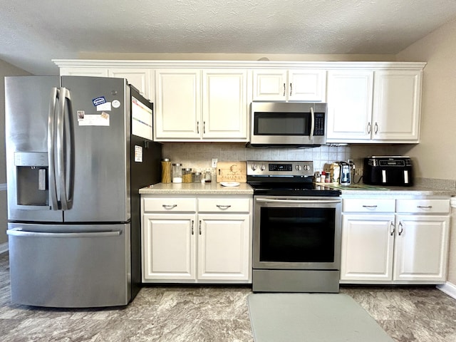 317 Hidden Loop Dr, Somerset, KY 42503 - kitchen featuring stainless steel appliances, white cabinetry, light countertops, backsplash, and a textured ceiling