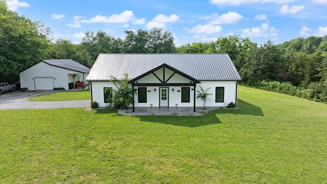 42 Cambron Ln, Raywick, KY 40060 - view of front of home with a garage, covered porch, a front yard, a metal roof, and driveway