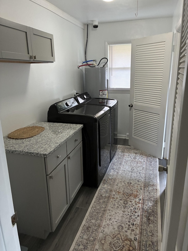 212 Baughman Ave, Danville, KY 40422 - laundry room featuring washer and clothes dryer, gas water heater, dark wood-style floors, and cabinet space