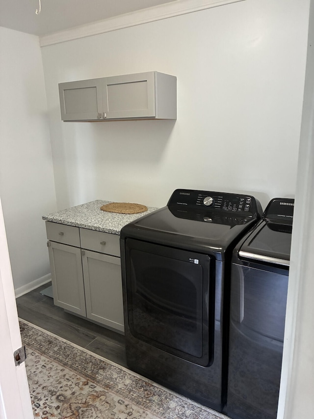 212 Baughman Ave, Danville, KY 40422 - laundry area featuring washer and clothes dryer, cabinet space, baseboards, and dark wood-type flooring