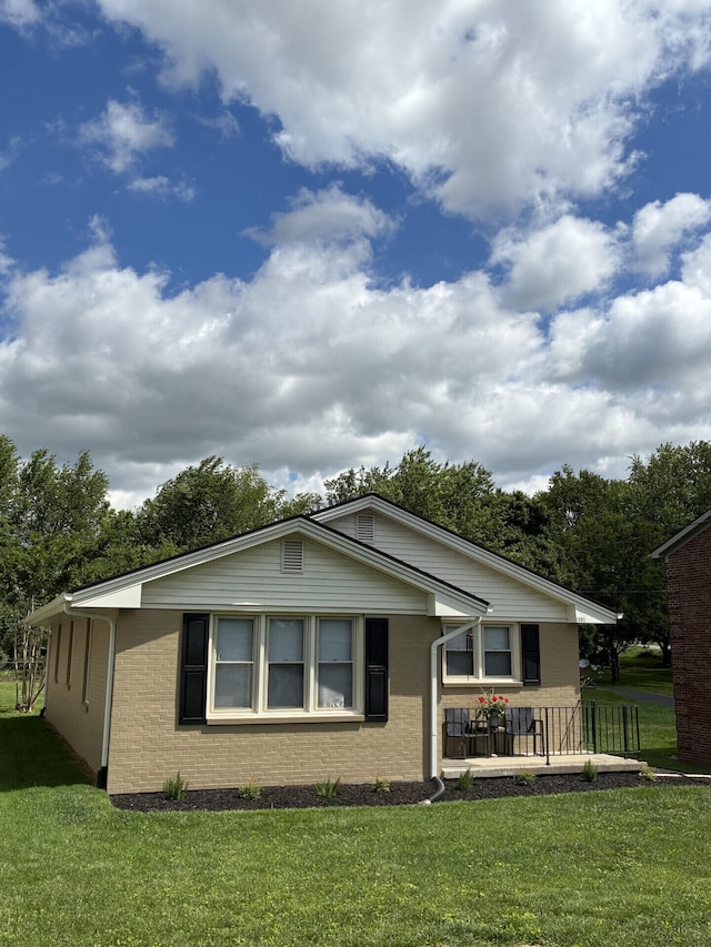 212 Baughman Ave, Danville, KY 40422 - view of home's exterior with brick siding and a lawn