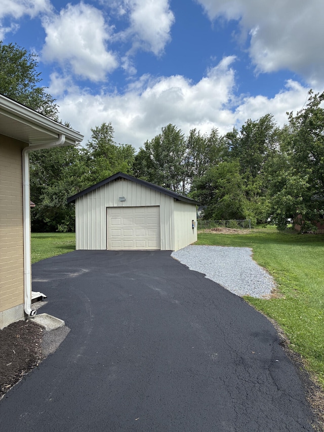 212 Baughman Ave, Danville, KY 40422 - detached garage featuring asphalt driveway and view of scattered trees