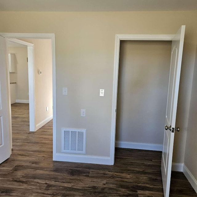 135 Watkins Branch Rd, East Bernstadt, KY 40729 - unfurnished bedroom with dark wood-type flooring and baseboards