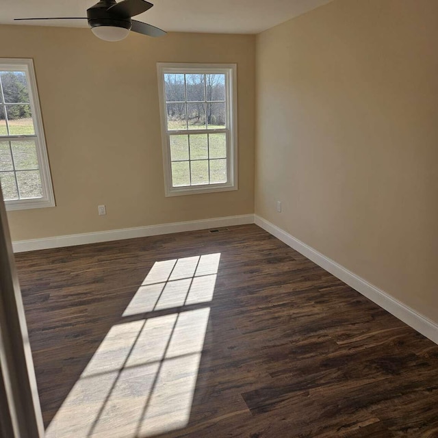 135 Watkins Branch Rd, East Bernstadt, KY 40729 - spare room with healthy amount of natural light, baseboards, and dark wood-style flooring