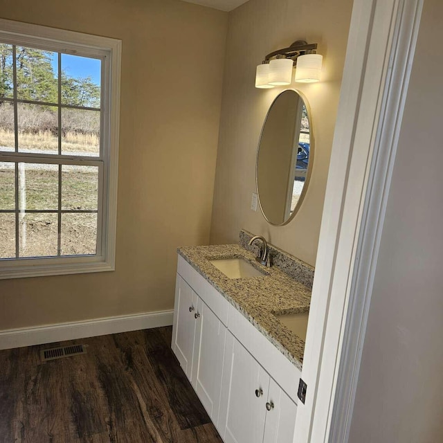 135 Watkins Branch Rd, East Bernstadt, KY 40729 - bathroom with baseboards, wood finished floors, and double vanity