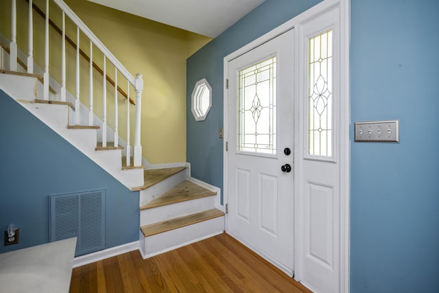 113 Medinah Ct, Frankfort, KY 40601 - foyer entrance featuring wood finished floors, stairs, and baseboards