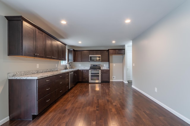 2296 Boonesborough Rd, Richmond, KY 40475 - kitchen with stainless steel appliances, dark brown cabinetry, dark wood finished floors, baseboards, and recessed lighting