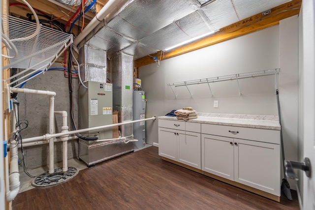 2296 Boonesborough Rd, Richmond, KY 40475 - unfinished basement featuring electric water heater, dark wood-type flooring, and heating unit