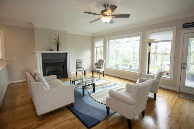 360 Persimmon Way, Harrodsburg, KY 40330 - living area featuring a fireplace, baseboards, light wood-style floors, ceiling fan, and ornamental molding