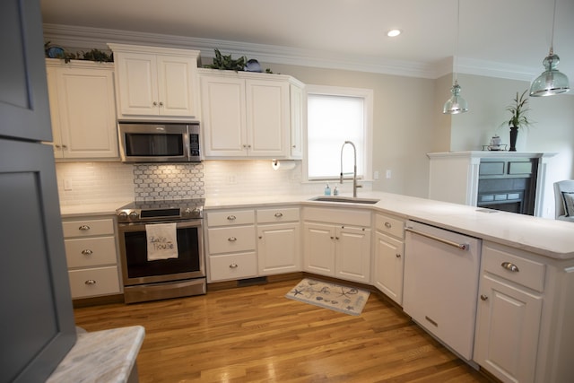 360 Persimmon Way, Harrodsburg, KY 40330 - kitchen featuring appliances with stainless steel finishes, a sink, a peninsula, white cabinets, and tasteful backsplash