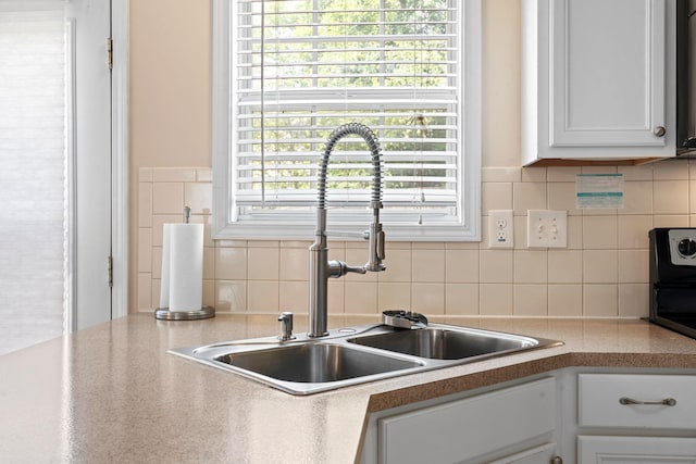 2109 Heath Land Pl, Lexington, KY 40516 - kitchen featuring a sink, tasteful backsplash, white cabinets, and light countertops