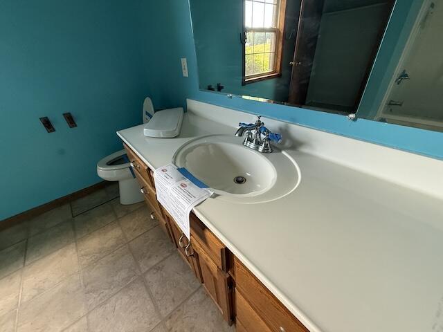 315 Della Winchester Rd, Nancy, KY 42544 - bathroom with toilet, vanity, and baseboards