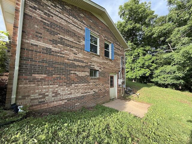 315 Della Winchester Rd, Nancy, KY 42544 - view of property exterior featuring a lawn and brick siding