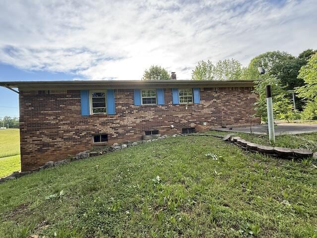 315 Della Winchester Rd, Nancy, KY 42544 - view of side of property with brick siding and a yard