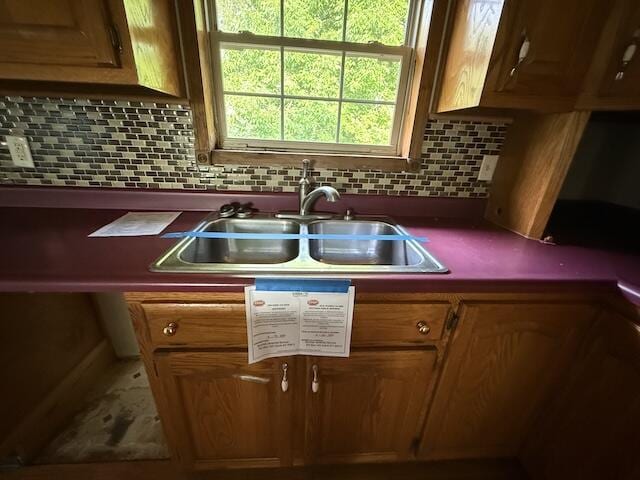 315 Della Winchester Rd, Nancy, KY 42544 - kitchen with a sink, backsplash, brown cabinets, and dark countertops
