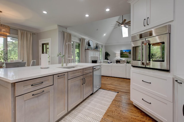 1304 Wakehurst Ct, Lexington, KY 40509 - kitchen with a sink, stainless steel dishwasher, a ceiling fan, a fireplace, and light wood finished floors