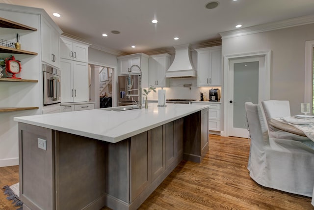1304 Wakehurst Ct, Lexington, KY 40509 - kitchen with custom range hood, ornamental molding, light wood-style floors, a sink, and white cabinetry