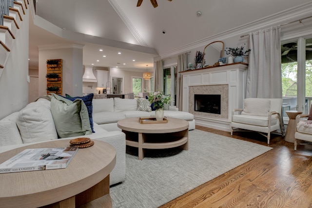 1304 Wakehurst Ct, Lexington, KY 40509 - living area featuring wood finished floors, a fireplace, ornamental molding, recessed lighting, and high vaulted ceiling