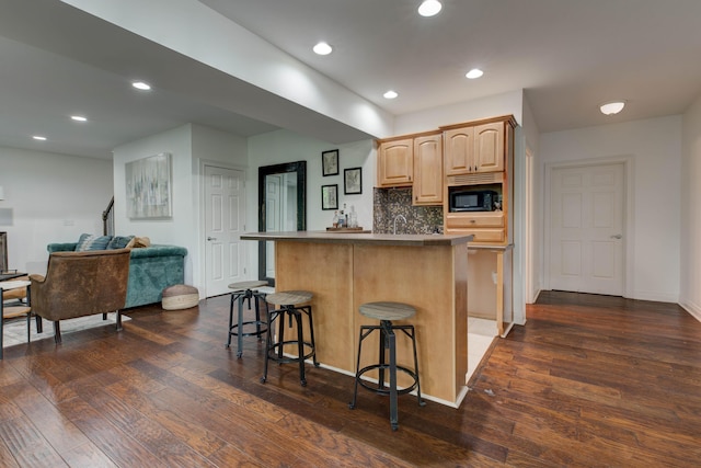 1304 Wakehurst Ct, Lexington, KY 40509 - kitchen featuring a breakfast bar, light brown cabinets, dark wood-style flooring, black microwave, and recessed lighting
