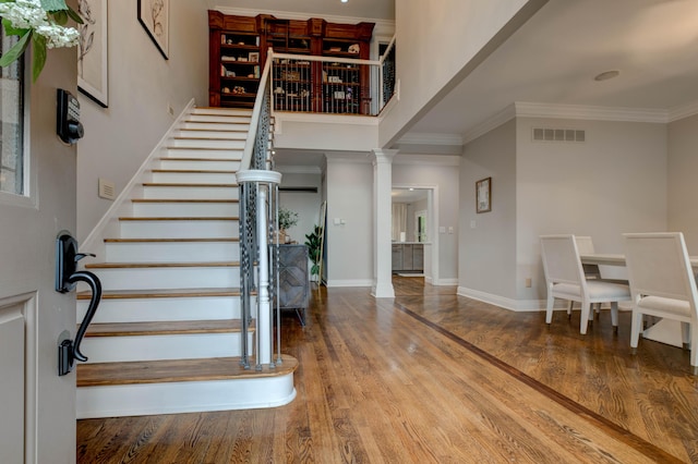 1304 Wakehurst Ct, Lexington, KY 40509 - stairway with wood finished floors, ornamental molding, baseboards, a high ceiling, and decorative columns