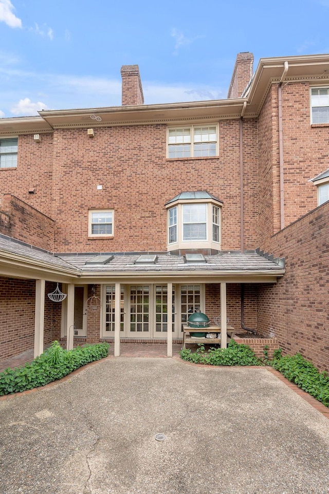 400 Redding Rd # 2, Lexington, KY 40517 - back of house featuring a chimney, brick siding, and a patio