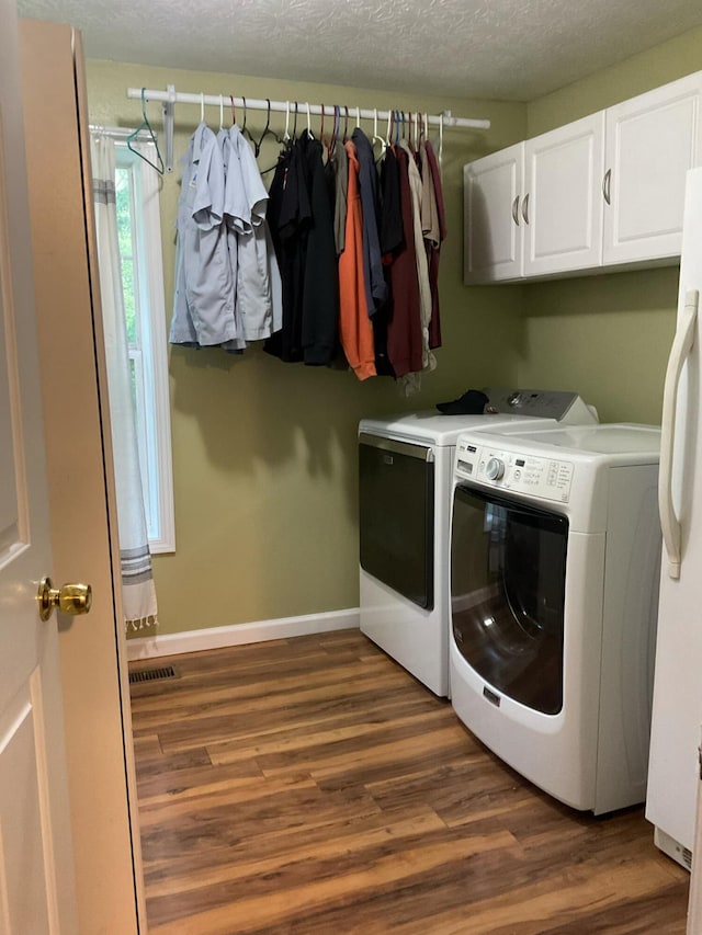 33 Banta Rd, Olive Hill, KY 41164 - laundry area featuring washer and clothes dryer, cabinet space, dark wood-type flooring, baseboards, and a textured ceiling