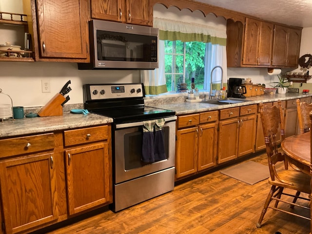 33 Banta Rd, Olive Hill, KY 41164 - kitchen featuring stainless steel appliances, a sink, dark wood-type flooring, brown cabinets, and light countertops