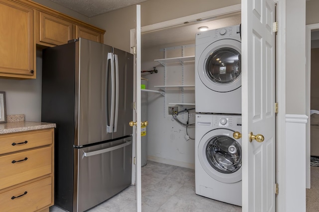 164 Strawberry Fields Rd, Lexington, KY 40516 - laundry area featuring stacked washer / drying machine and baseboards