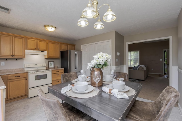 164 Strawberry Fields Rd, Lexington, KY 40516 - kitchen with freestanding refrigerator, white range with electric stovetop, under cabinet range hood, light countertops, and a chandelier